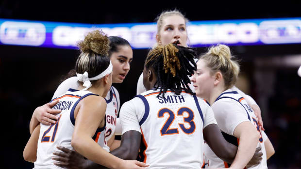 Kymora Johnson, Alexia Smith, Cady Pauley, Taylor Lauterbach, and Edessa Noyan huddle during the Virginia women's basketball game against North Carolina at John Paul Jones Arena.